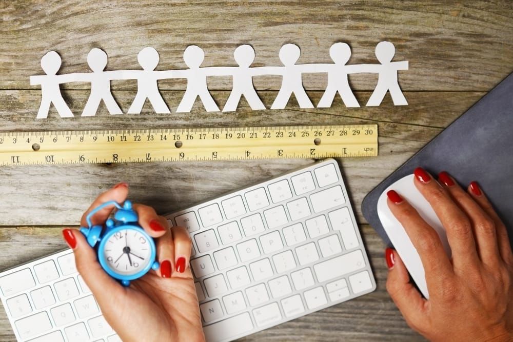 eam members evaluation or performance management concept with human silhouettes measured with wooden ruler